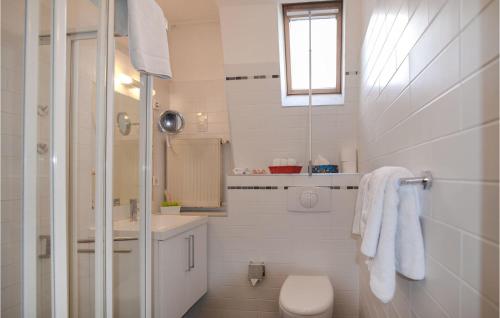 a white bathroom with a toilet and a sink at 2 Bedroom Lovely Home In Berlin in Berlin