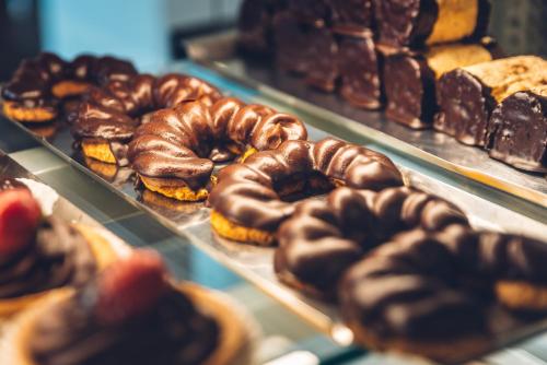 a display case filled with lots of different types of donuts at Penzion U Madony in Česká Lípa