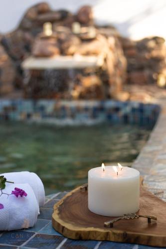 a candle sitting on a table next to a pool at Villa Can Kiko in Dahab