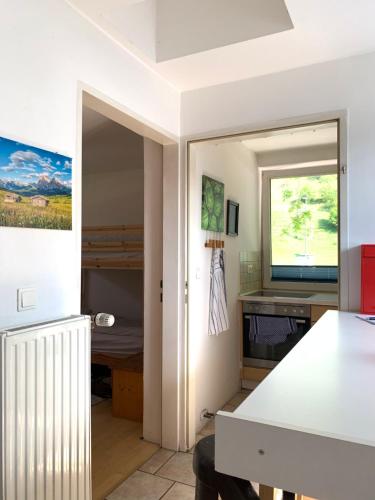 a room with a room with a bed and a window at Blue Mountain Hostel in Innsbruck