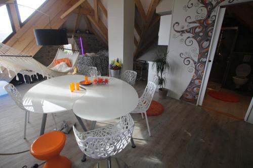 a white table and chairs in a living room at Loft "Home, Sauna & Pool" in Osenbach