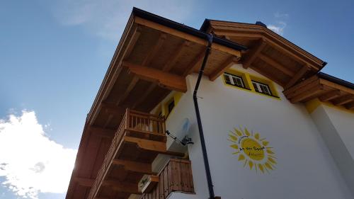 a building with a clock on the side of it at Haus Garten An der Sonne in Niedernsill