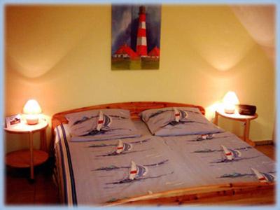 a bedroom with a bed with boats on it at Haus Moewennest in Gelting