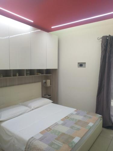 a bedroom with a bed and white cabinets at B&B Vistamareblu in San Foca