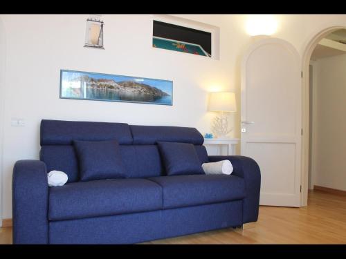 a blue couch sitting in a living room at Sea suite positano in Positano