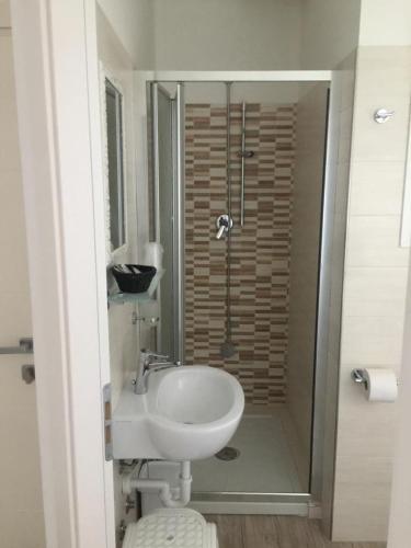 a bathroom with a white sink and a shower at HOTEL GIAMAICA in Cattolica