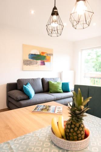 a living room with a table with a bowl of fruit at Haus Nowak Ferienwohnungen in Millstatt