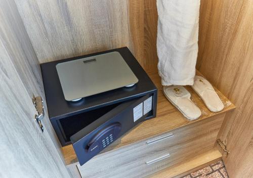 a laptop computer sitting on top of a box in a door at Rose Plaza Hotel Al Barsha in Dubai
