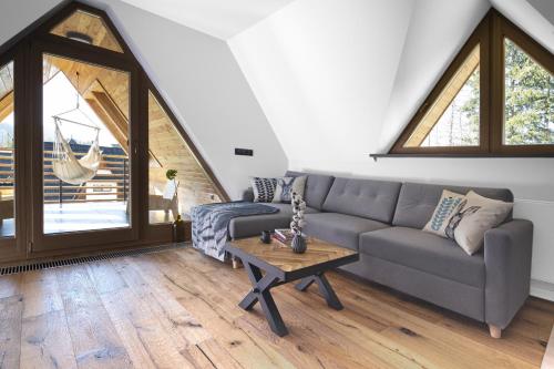 a living room with a couch and a table at Green Deer Premium in Zakopane