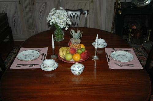 a wooden table with a bowl of fruit on it at 29 India House in Nantucket