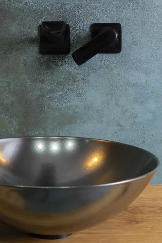 a metal bowl sitting on a table with a knife at Green Deer Premium in Zakopane