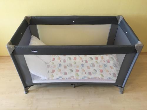 a small black crib with a pillow in it at Apartmán Bešeňová 289 in Bešeňová