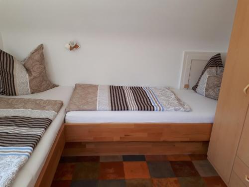 a small bedroom with a bed with a white at Ferienwohnung Frühlingsau in Freudenstadt