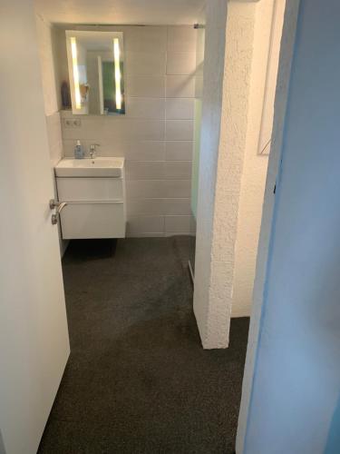 a bathroom with a sink and a mirror at Ferienwohnung Hoppe in Bad Münder am Deister