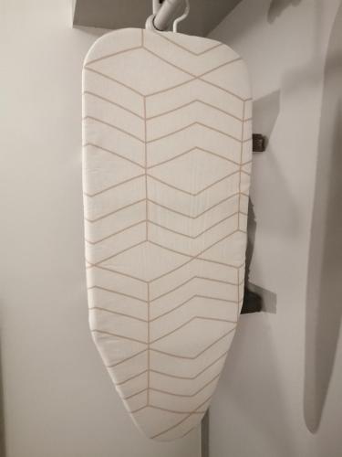 a white surfboard hanging on a wall at The Romantic Waterloo Lion's suite in Braine-lʼAlleud