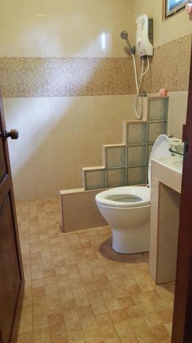 a bathroom with a toilet and a sink at Sweetville Home in Sangkhla Buri