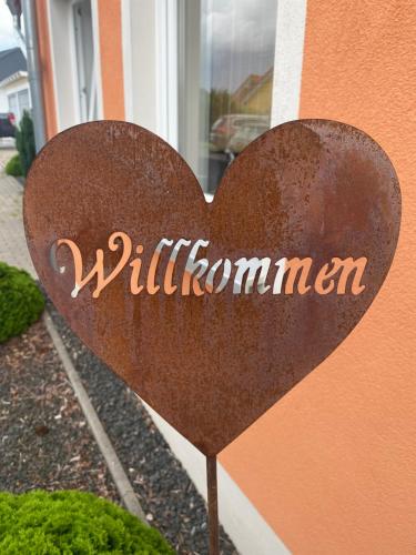 a heart sign in front of a building at Steigerwaldblick Apartments Burgebrach in Burgebrach