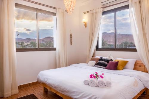 a bedroom with a bed with two towels on it at Villa Can Kiko in Dahab