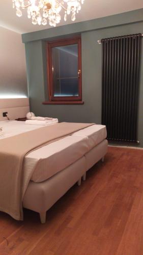 a bedroom with a large bed and a window at Dolomitiloungebelluno Mountain resources in Belluno