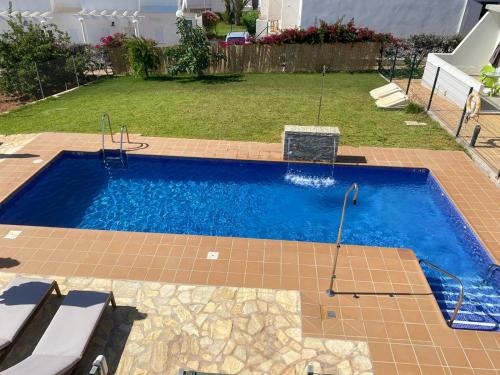 a swimming pool in a yard with at Mda Playa del Cantal in Mojácar