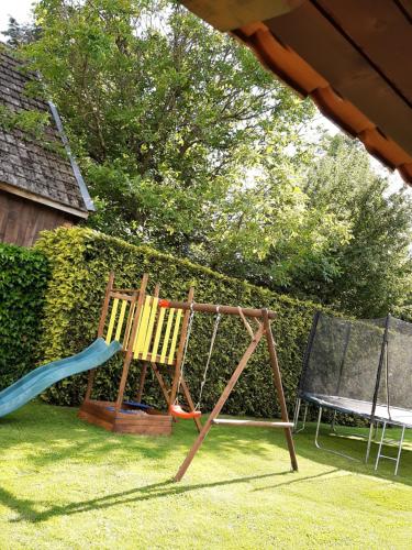 two chairs and a swing in a yard at Privat Mária in Liptovský Ján