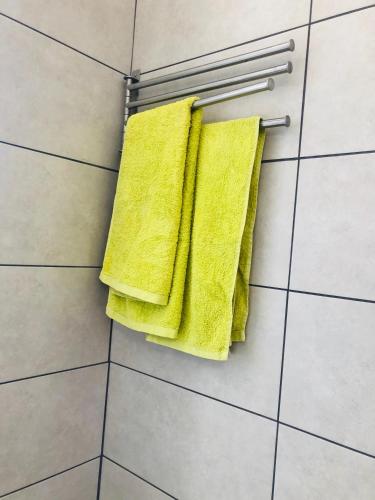 a pair of yellow towels hanging on a towel rack at Las Vistas Beach in Playa de las Americas