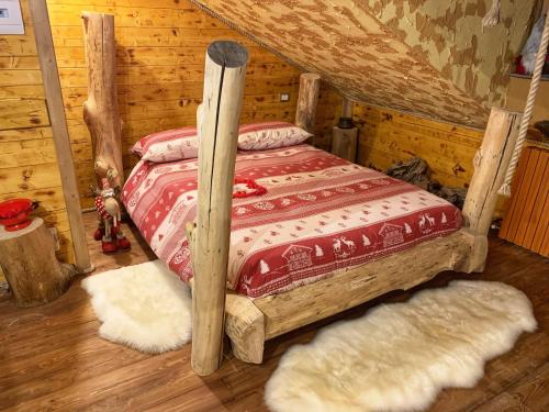a bedroom with a bed in a log cabin at ALLA STALLA Suite & Chalet in Piazzatorre