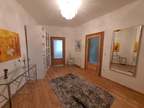 an empty living room with wooden floors and doors at Domizil Adler in Dresden