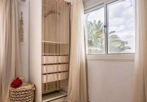 a bathroom with a window and a curtain at Villa Can Kiko in Dahab