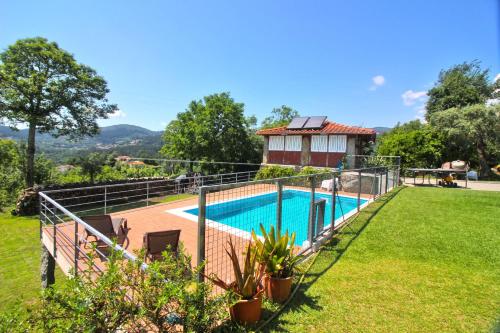 a villa with a swimming pool and a house at Casa Roupar by Gerês Casas in Terras de Bouro