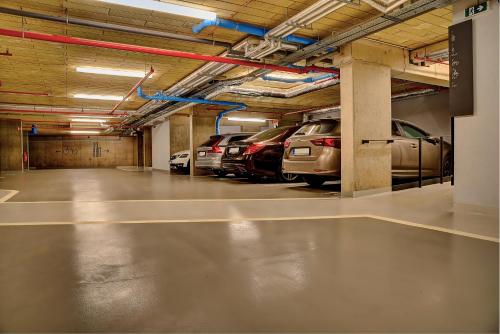 a parking garage with cars parked in it at Grand Hotel Hradec in Pec pod Sněžkou