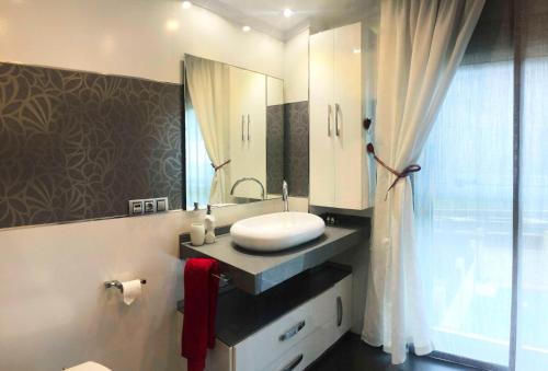 a bathroom with a sink and a mirror at Chalet Vilanova in Cee