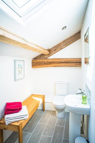 a bathroom with a toilet and a sink at Widewath Barn in Penrith