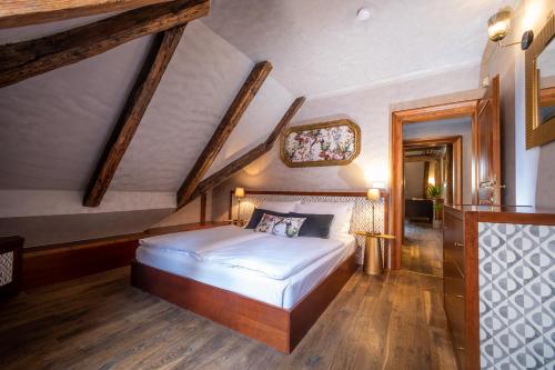 a bedroom with a large bed in a attic at Miss Sophie's Charles Bridge in Prague