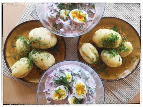three plates of food with eggs on a table at Rancho Relaxo Czartoria in Miączyn