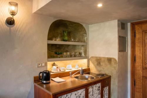 a kitchen with a sink and a counter top at Miss Sophie's Charles Bridge in Prague