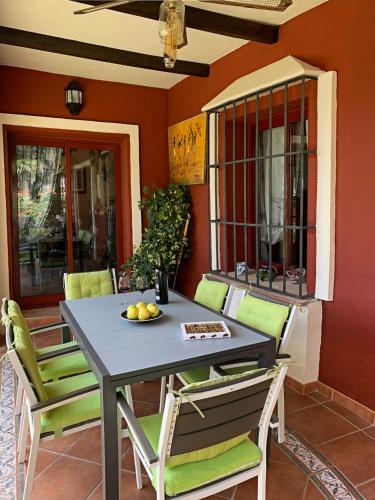 a table and chairs on a patio at VILLA NABRISA MARBELLA, 5 BEDROOM, PRIVATE POOL, GARDEN, BBQ in Marbella