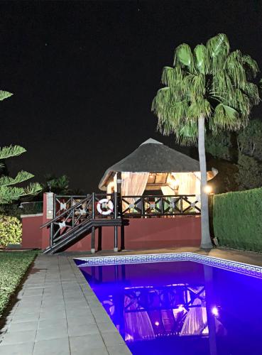 a swimming pool at night with a gazebo at VILLA NABRISA MARBELLA, 5 BEDROOM, PRIVATE POOL, GARDEN, BBQ in Marbella