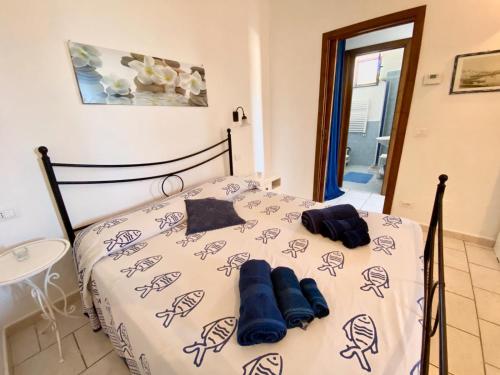 a bedroom with a bed with blue pillows on it at Case Vacanze Marina Longo in Santa Marina Salina