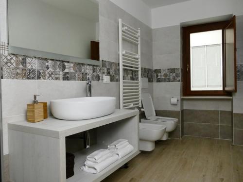 a bathroom with a sink and a toilet at IL NIDO L'Aquila in LʼAquila