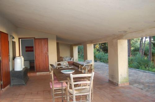 a dining room with a table and chairs on a patio at Case di Berto in Capo Vaticano