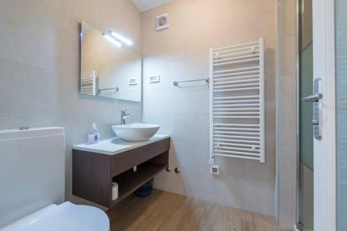 a bathroom with a sink and a toilet and a shower at Villa Sarah in Lopud Island
