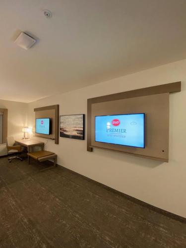 a hotel room with a television on a wall at Best Western Premier Prince Albert in Prince Albert