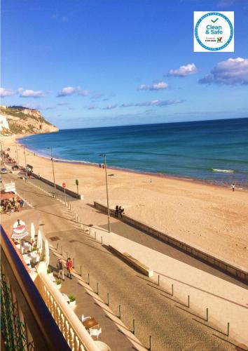 a view of a beach and the ocean at Casa vista Azul in Sesimbra