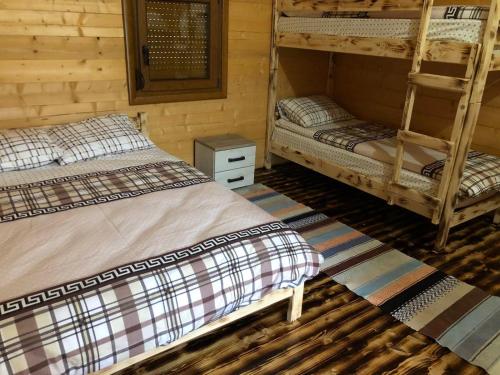 a room with two bunk beds in a cabin at Ethno House Bektesevic in Gusinje