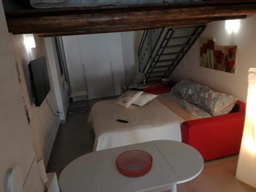 a room with two beds and a table and a staircase at LA CASETTA DI MARTA ai Quattro Canti di Giusi in Palermo