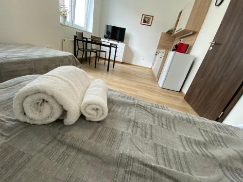 a bedroom with two towels sitting on a bed at No. 34 in Hradec Králové