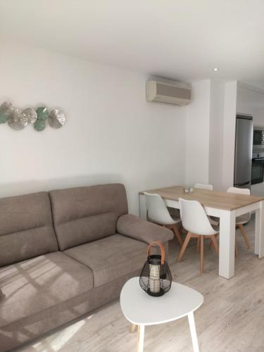 a living room with a couch and a table at Casa Trinitat in Altea