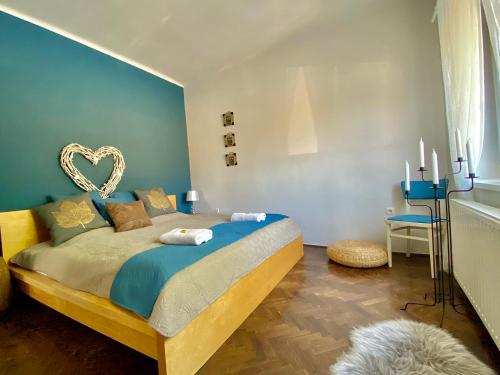 a bedroom with a bed with a heart decoration on it at Bíborlak 6 in Villány