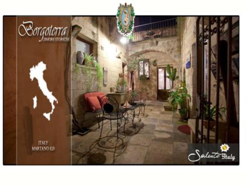 a room with a table and chairs in a building at Borgoterra in Martano